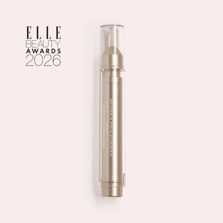 Lydia Esthetics Embassy A gold beauty serum pen with a clear cap is displayed vertically on a light background. “ELLE Beauty Awards 2026” text appears in the top left corner. New York